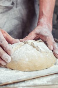 A baker kneading bread